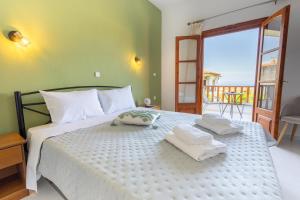 a bedroom with a bed with two towels on it at Horizon Studios Afitos in Afitos