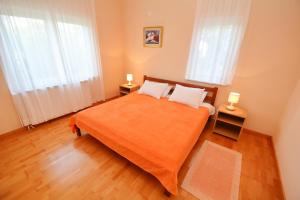 a bedroom with a bed with two lamps on it at Apartments Soso in Kotor
