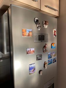 a refrigerator with a bunch of pictures on it at Velvet Living Luxury Apartment in Skopje