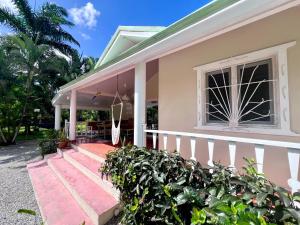 a house with a porch and a window at PETRAKl HOMES in Las Galeras