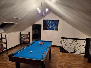 a pool table in a room with a ceiling at Home from home in Le Haut-Corlay
