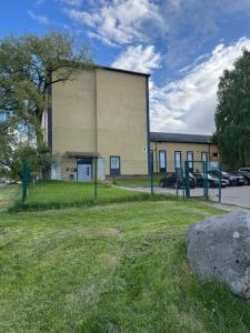 a large building with cars parked in a parking lot at 5 New Airport Apartment in VNO