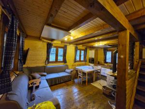 a living room with a couch and a table at Chaty Jelenye in Turzovka