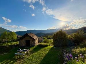 a stone house on a hill with a picnic table at La bergerie Leffler in Buerba