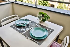 a white table with plates and glasses on it at O métro Jean jaures in Lyon