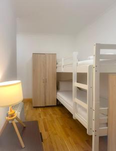 a room with bunk beds with a desk and a chair at Budget 29 in London +1 photo