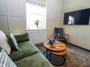 a living room with a couch and a table at Gavel Cottage in Whitby