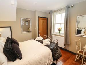 a bedroom with two beds and a window at Gavel Cottage in Whitby