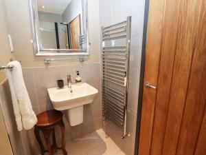 a small bathroom with a sink and a mirror at Gavel Cottage in Whitby +15 photos