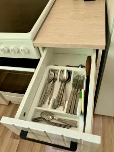 a drawer in a kitchen with utensils at The art place in Vidin