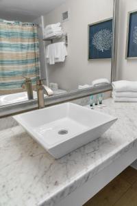 a white sink on a counter in a bathroom at Modern & Updated Oceanview Studio! Sleeps 4! Landmark 523 in Myrtle Beach