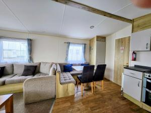 a living room with a couch and a table at Leysdown Little Escapes in Leysdown-on-Sea