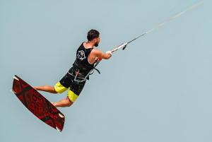 a man is in the air on a surfboard at Arena Beach Resort - Premium Suites in Hurghada