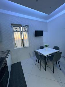 a dining room with a white table and chairs at L' Aurora Azzurra casa vacanze Casa Maria in Trecase