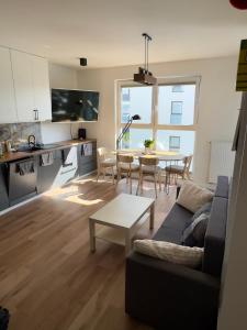 a living room with a couch and a table at Navy Blue Apartment in Gdynia +25 photos