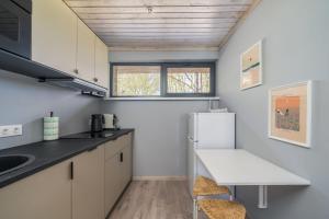 a kitchen with white cabinets and a white refrigerator at Ruby Oasis in Jurmala in Jūrmala