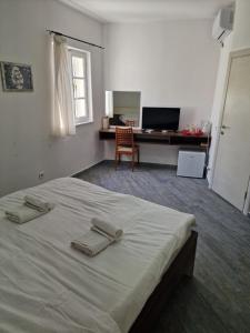 a bedroom with a bed with two towels on it at Rooms Dana Old Town Budva in Budva +25 photos