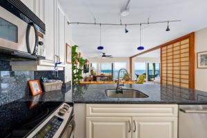 a kitchen with a sink and a counter top at Big Island Alii Villas 333 by Coldwell Banker Island Vacations in Kailua-Kona