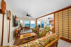 a living room with a couch and a table at Big Island Alii Villas 333 by Coldwell Banker Island Vacations in Kailua-Kona