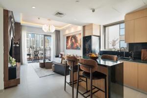 a kitchen with a bar and a living room at qua Serenity Poolside with Community Views in Dubai