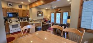 a kitchen and living room with a table and chairs at Our Heart's Desire- spacious 3 BR condo with hot tub in great location! in McHenry