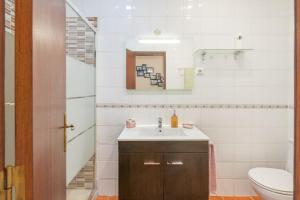 a bathroom with a sink and a toilet at Milfontes Beach House in Vila Nova de Milfontes +27 photos