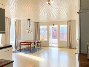 a kitchen and dining room with a table and chairs at Countryside retreat for 4 guests in Skånes Fagerhult