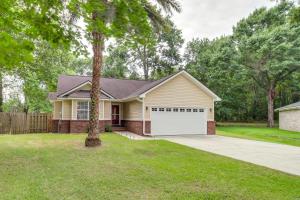 a house with a palm tree in a yard at Deck and Yard Savannah Area Retreat! in Savannah