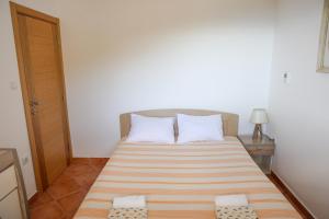 a small bedroom with a bed with two pillows at Residence Vukovic, Rezevici in Reževići +38 photos