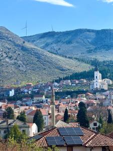 a view of a town with a mountain in the background at Studio Sparky in Mostar