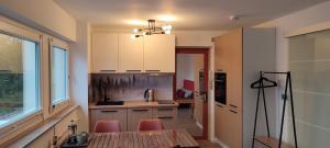 a kitchen with a table and chairs and a counter at Schwarzwaldstübchen "Altas Montañas" mit Schwimmbad in Baiersbronn
