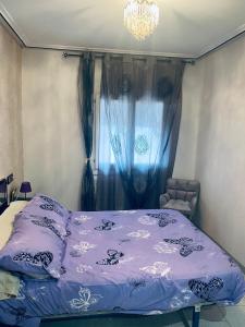 a bed with a purple comforter in a bedroom at Casona Mayor in Andorra