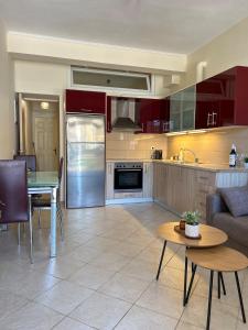 a kitchen and living room with a table and a couch at Vathi Seaside Apartment in Meganisi