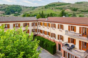 an aerial view of a building with hills in the background at Hôtel Beau Rivage Condrieu in Condrieu +50 photos