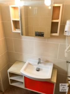 a bathroom with a sink and a mirror at Casas Da Lagoa - T2 Sul in Aldeia de Brescos +13 photos