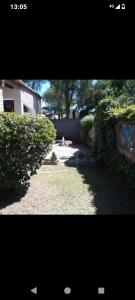a view of a yard with trees and a building at La casita in Mendoza +1 photo