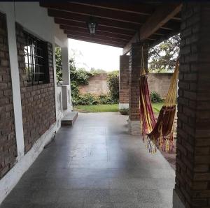a patio with hammocks hanging from a brick building at La casita in Mendoza