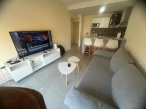 a living room with a couch and a flat screen tv at Calmo y luminoso cercano a avenida Avellaneda in Buenos Aires