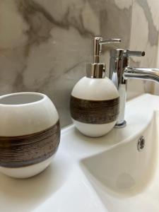 a bathroom sink with a soap dispenser on it at Your Italian Home in San Pietro in Cariano