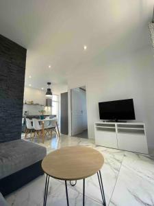 a living room with a couch and a table at Casa Sanna, T2 waterfront Miomo, Cap Corse in Santa-Maria-di-Lota