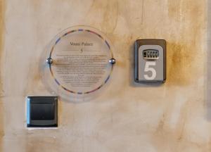 a wall with a temperature plate and a tv at 22 Yedia North Nicosia Turkish Side in Nicosia