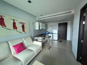 a living room with a white couch and a pink pillow at Emerald Terrace Condo 9-1 Bed City & Mountain in Patong Beach