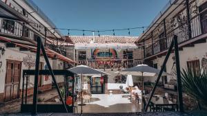 un cortile di un edificio con ombrelloni di Terra House Hostel a Cuzco