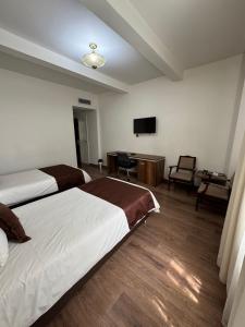 Letto o letti in una camera di Hotel Nutibara