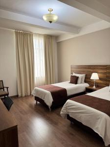 Letto o letti in una camera di Hotel Nutibara