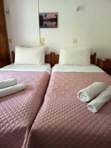 two beds sitting next to each other in a room at Eleni's Rooms in Samothraki +1 photo