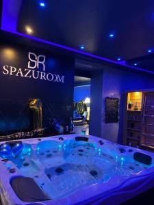 una vasca idromassaggio in una stanza con un cartello di Spazuroom Luxury Suite a Mouscron