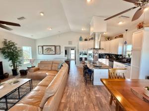 a living room and kitchen with a couch and a table at The Salty Pelican Flagler Beach in Flagler Beach