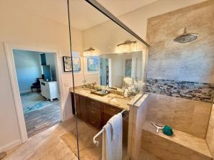 a large bathroom with a shower and a sink at The Salty Pelican Flagler Beach in Flagler Beach +49 photos