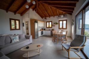 a living room with a couch and a table at Villa Lithos in Katouna